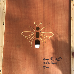 Artistic image of bee on piece of wood.