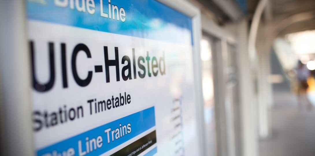 Close up picture of UIC-Halsted CTA Blue Line train station sign