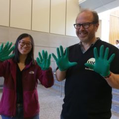 Two people in a lab wearing nitrile gloves